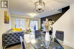 Dining room with hardwood / wood-style floors and a chandelier - 