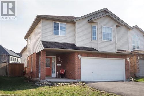 View of front of home featuring covered porch, a garage, and a front lawn - 17 Hawkswood Drive, Kitchener, ON - Outdoor