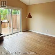 Empty room with light hardwood / wood-style floors and vaulted ceiling - 