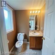 Bathroom with tile patterned flooring, vanity, and toilet - 