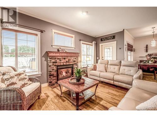 view of sunroom and rear yard - stunning - 3515 Ridge Boulevard, West Kelowna, BC - Indoor Photo Showing Living Room With Fireplace