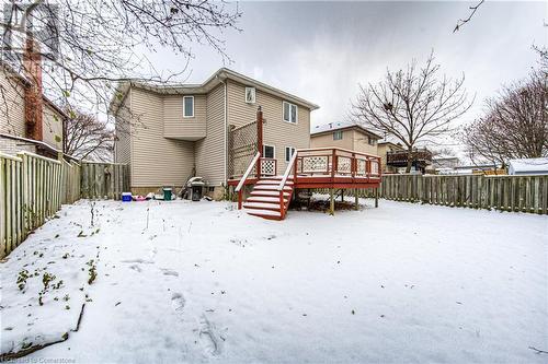 Snow covered rear of property with a wooden deck - 21 Woodborough Place, Cambridge, ON - Outdoor With Deck Patio Veranda