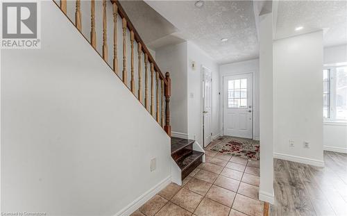 Foyer entrance featuring a textured ceiling, light hardwood / wood-style flooring, and a wealth of natural light - 21 Woodborough Place, Cambridge, ON - Indoor Photo Showing Other Room