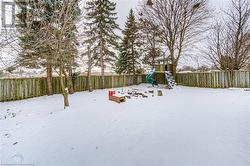 Yard layered in snow with a playground - 