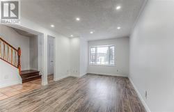 Spare room featuring a textured ceiling and hardwood / wood-style flooring - 