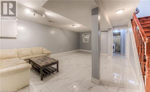 Unfurnished living room with a textured ceiling and washer / dryer - 21 Woodborough Place, Cambridge, ON - Indoor