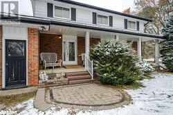 Snow covered property entrance featuring a porch - 