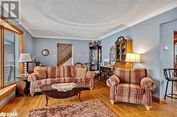 Living room featuring light hardwood / wood-style floors and crown molding - 