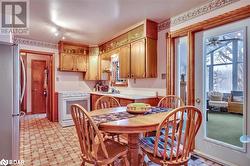 Kitchen featuring stainless steel refrigerator, sink, and white electric stove - 