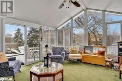 Sunroom with vaulted ceiling with beams, a wealth of natural light, and ceiling fan - 