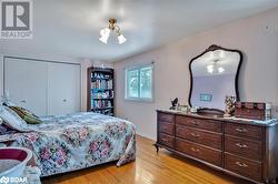 Bedroom featuring a closet and light hardwood / wood-style floors - 