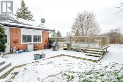 Snow covered deck featuring a grill - 