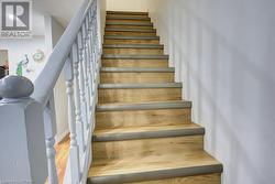 Stairs featuring hardwood / wood-style flooring - 