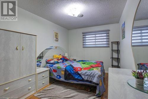 Bedroom with wood-type flooring and a textured ceiling - 255 Lansdowne Avenue Unit# 3, Woodstock, ON - Indoor Photo Showing Bedroom