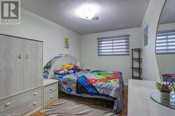 Bedroom with wood-type flooring and a textured ceiling - 