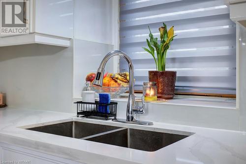 Interior details with white cabinets, light stone countertops, and sink - 255 Lansdowne Avenue Unit# 3, Woodstock, ON - Indoor Photo Showing Kitchen With Double Sink