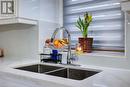 Interior details with white cabinets, light stone countertops, and sink - 255 Lansdowne Avenue Unit# 3, Woodstock, ON  - Indoor Photo Showing Kitchen With Double Sink 