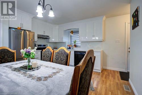 Dining space with light wood-type flooring, sink, and an inviting chandelier - 255 Lansdowne Avenue Unit# 3, Woodstock, ON - Indoor Photo Showing Dining Room