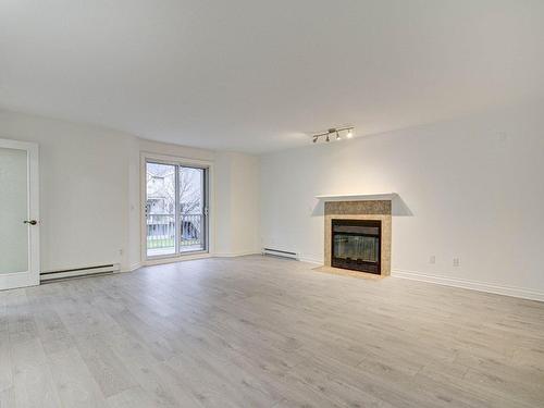 Salon - 6813 Rue Marie-Guyart, Montréal (Lasalle), QC - Indoor Photo Showing Living Room With Fireplace