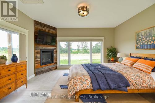 7761 Mcarthur Side Road, Ramara, ON - Indoor Photo Showing Bedroom With Fireplace