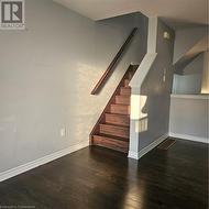 Staircase with hardwood / wood-style floors - 