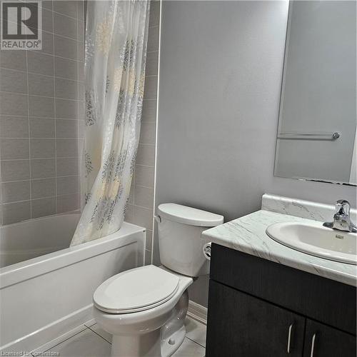 Full bathroom with tile patterned floors, shower / bath combo with shower curtain, vanity, and toilet - 39 Appleby Street, Kitchener, ON - Indoor Photo Showing Bathroom