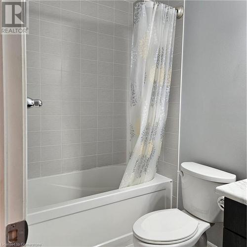 Full bathroom featuring vanity, shower / bath combo, and toilet - 39 Appleby Street, Kitchener, ON - Indoor Photo Showing Bathroom