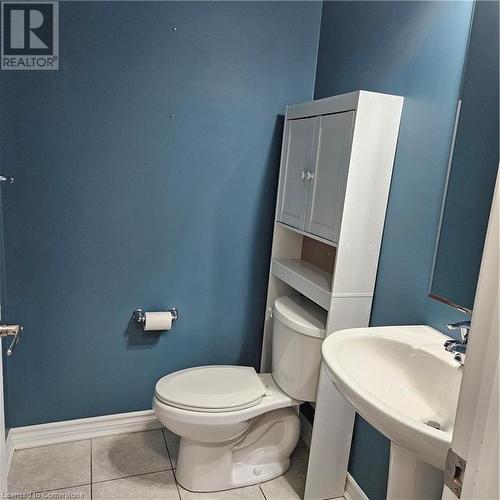 Bathroom featuring tile patterned flooring, toilet, and sink - 39 Appleby Street, Kitchener, ON - Indoor Photo Showing Bathroom