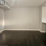 Unfurnished room with dark hardwood / wood-style floors - 