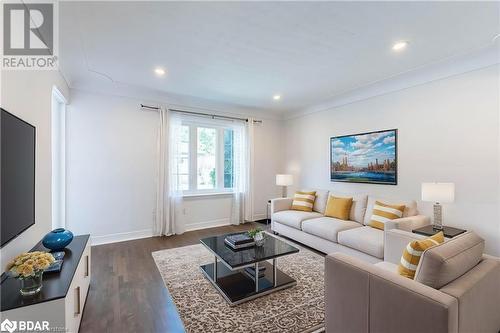 Living room featuring dark wood-type flooring - 90 East 11Th Street, Hamilton, ON - Indoor Photo Showing Living Room