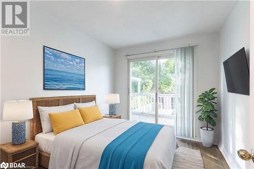 Bedroom featuring access to exterior and wood-type flooring - 90 East 11Th Street, Hamilton, ON - Indoor Photo Showing Bedroom