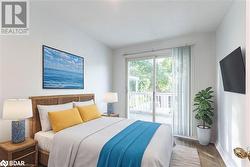 Bedroom featuring access to exterior and wood-type flooring - 