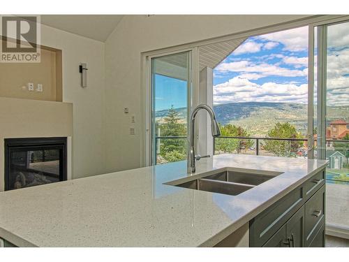 6857 Madrid Way Unit# 336, Kelowna, BC - Indoor Photo Showing Kitchen With Fireplace With Double Sink