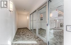 Hallway featuring carpet and a paneled ceiling - 