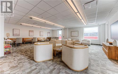 Living room featuring a drop ceiling and carpet floors - 301 Westmount Road W Unit# 204, Kitchener, ON - Indoor