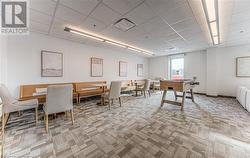 Carpeted dining area with a paneled ceiling - 