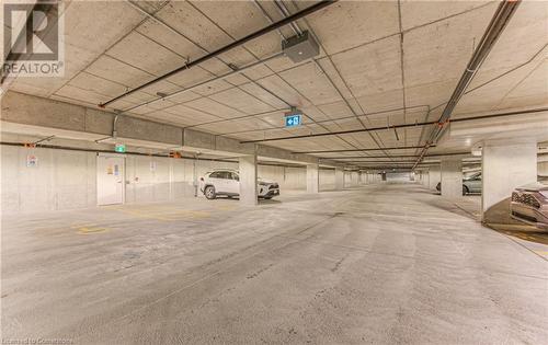 Garage featuring a garage door opener - 301 Westmount Road W Unit# 204, Kitchener, ON - Indoor Photo Showing Garage