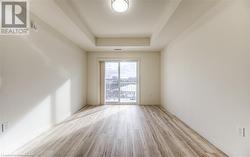 Unfurnished room with a raised ceiling and light hardwood / wood-style floors - 