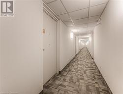 Corridor with carpet floors and a drop ceiling - 