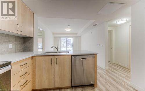 Kitchen with light brown cabinetry, stainless steel appliances, light wood-type flooring, and sink - 301 Westmount Road W Unit# G1, Kitchener, ON - Indoor Photo Showing Kitchen With Double Sink