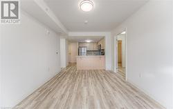 Unfurnished living room featuring light wood-type flooring - 