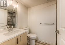 Bathroom featuring vanity, toilet, and wood-type flooring - 