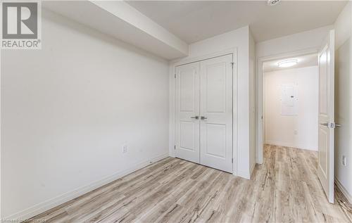 Unfurnished bedroom featuring electric panel, a closet, and light hardwood / wood-style floors - 301 Westmount Road W Unit# G1, Kitchener, ON - Indoor Photo Showing Other Room