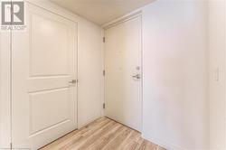 Corridor with light hardwood / wood-style flooring - 