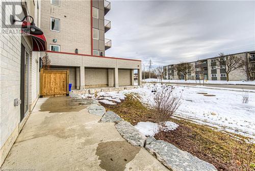 View of yard layered in snow - 301 Westmount Road W Unit# G1, Kitchener, ON - Outdoor With Exterior