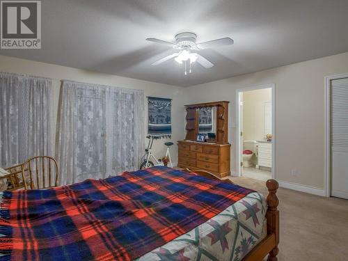 Primary bedroom with ensuite and entrance to patio - 11900 Olympic View Drive, Osoyoos, BC - Indoor Photo Showing Bedroom