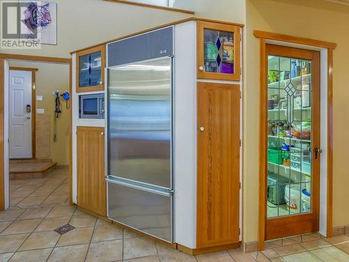 Oversized built in refrigerator and large walk-in pantry - 11710 Olympic View Drive, Osoyoos, BC - Indoor Photo Showing Other Room