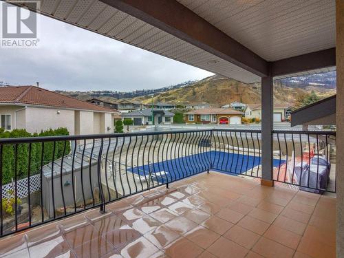 Private patio off primary bedroom overlooking salt water pool - 11710 Olympic View Drive, Osoyoos, BC - Outdoor With In Ground Pool With Balcony With Exterior