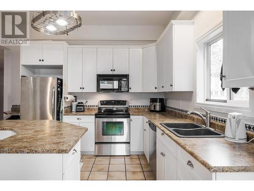 Kitchen with Stainless appliances, and large island- great for entertaining - 615 Sutherland Avenue, Kelowna, BC - Indoor Photo Showing Kitchen With Double Sink