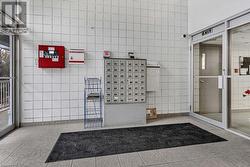 Bathroom with tile patterned floors and tile walls - 